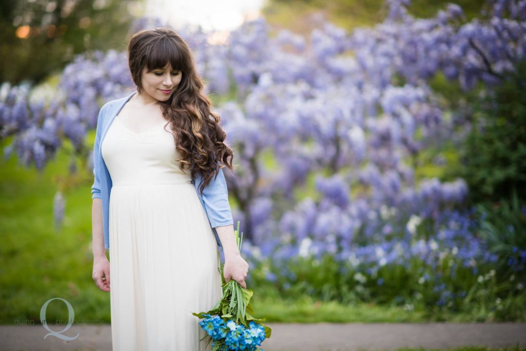 blue maternity in park flowers