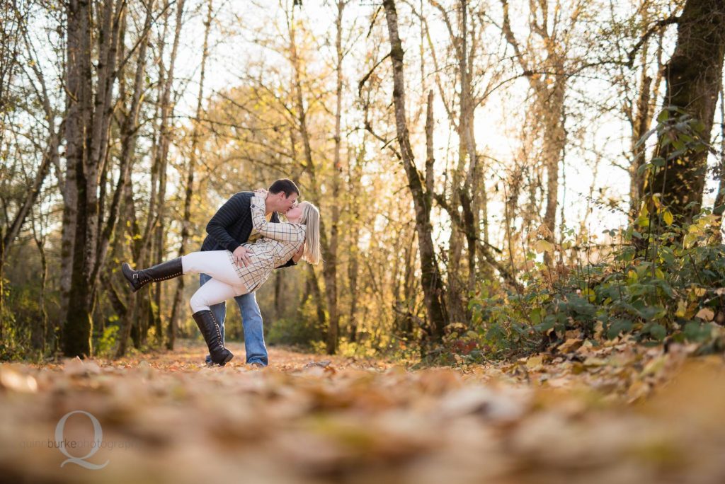 engagement photo kiss fall leaves