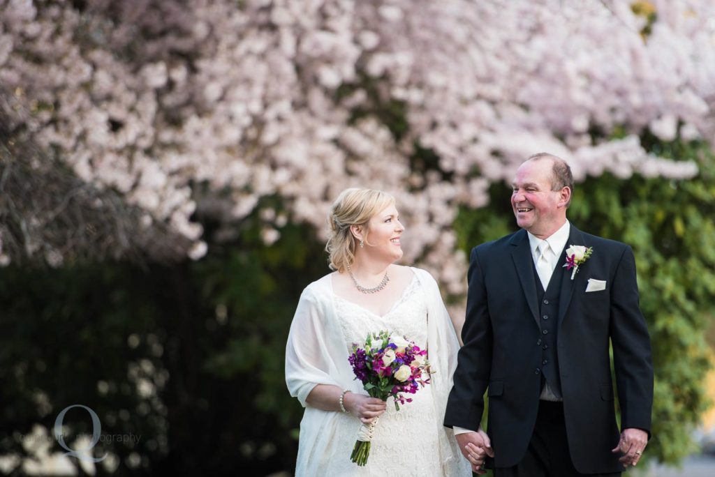 bride groom walking cherry blossoms