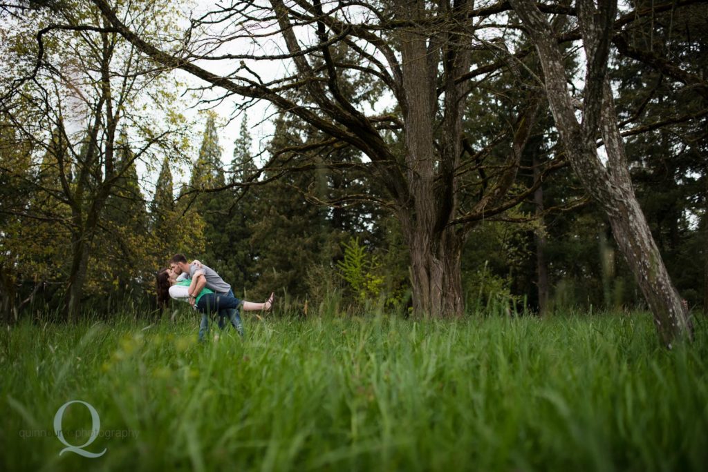 engagement dip kiss in park 