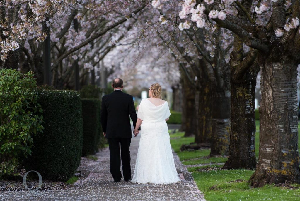 bride groom walking cherry blossoms