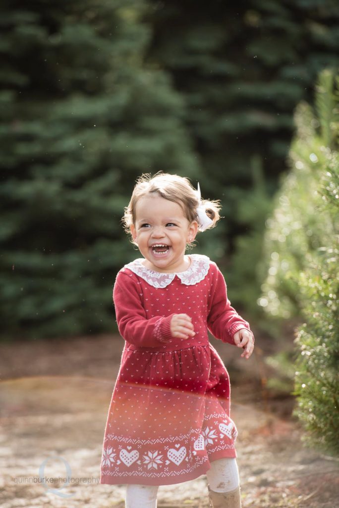 little girl happy at christmas tree farm