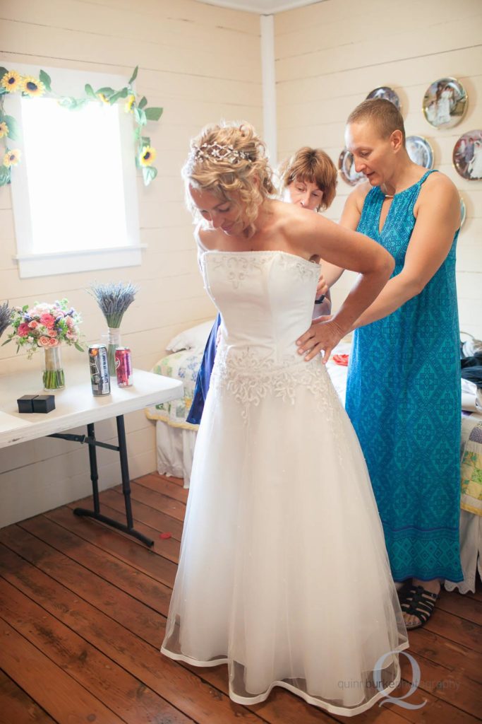 bride putting on wedding dress