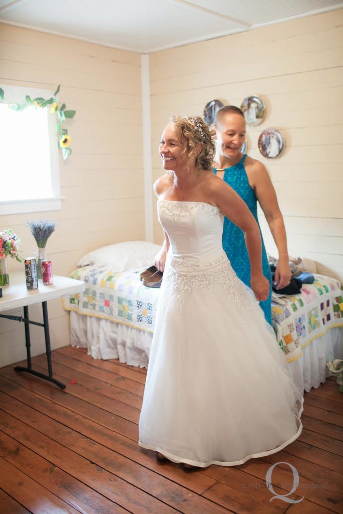 bride putting on wedding dress