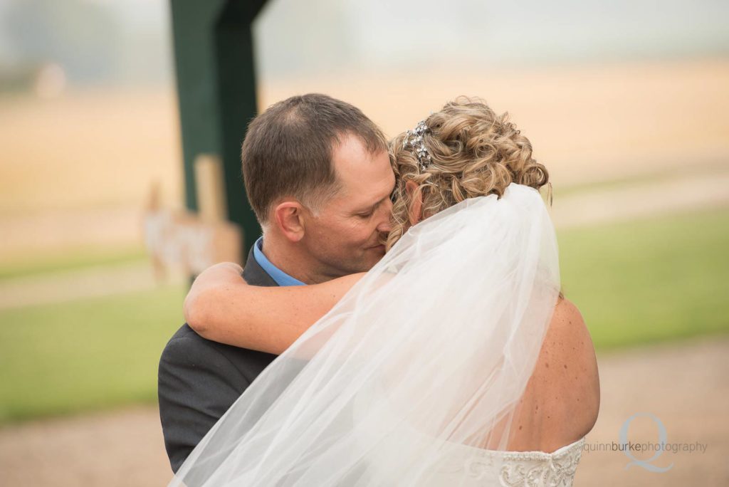 groom hugging bride first look