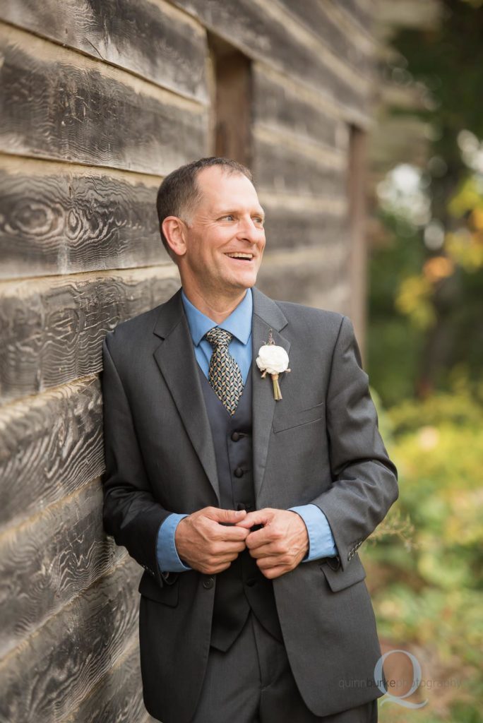 groom portrait against barn