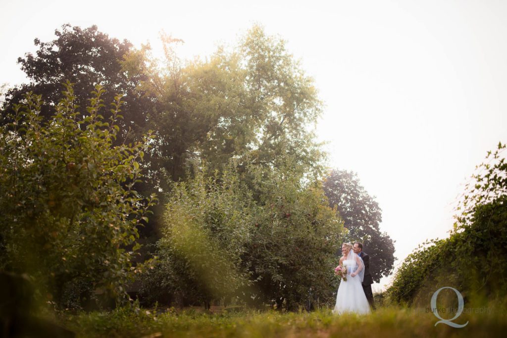 bride and groom in orchard