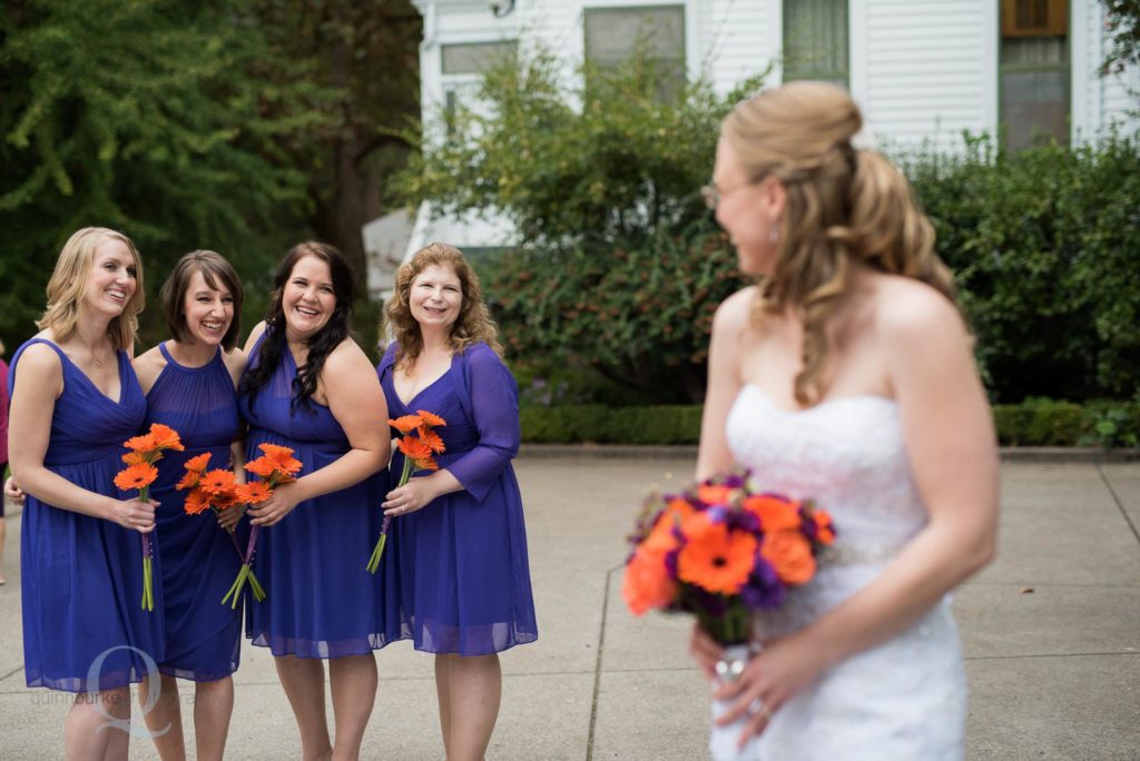 bridesmaids looking at bride