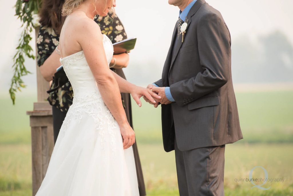 groom placing ring on finger