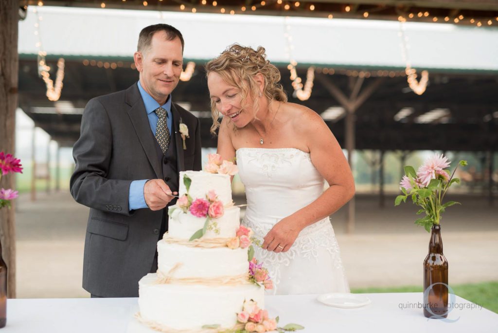 bride and groom cut wedding cake