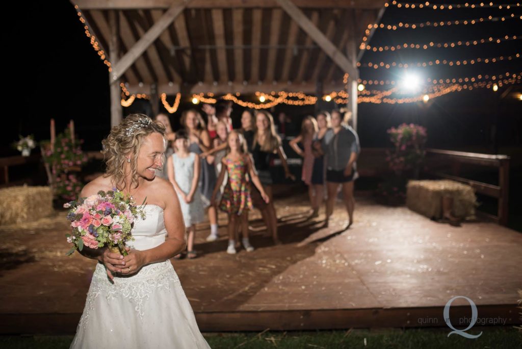 bride throwing flower bouquet