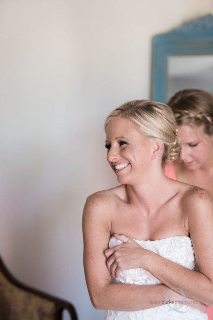 bride putting on dress