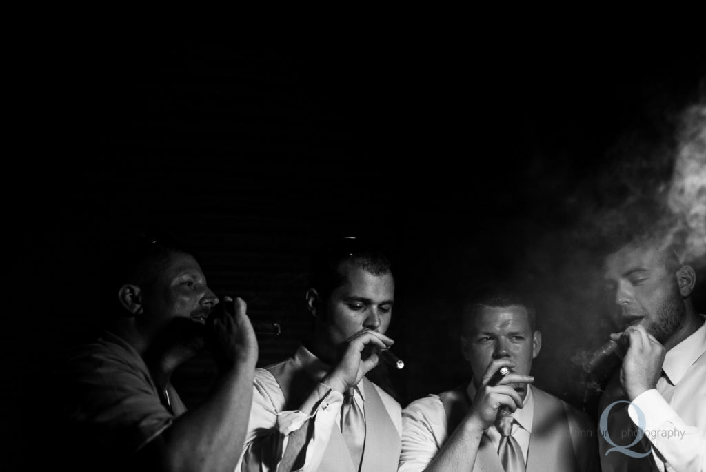 Groomsmen smoking cigars