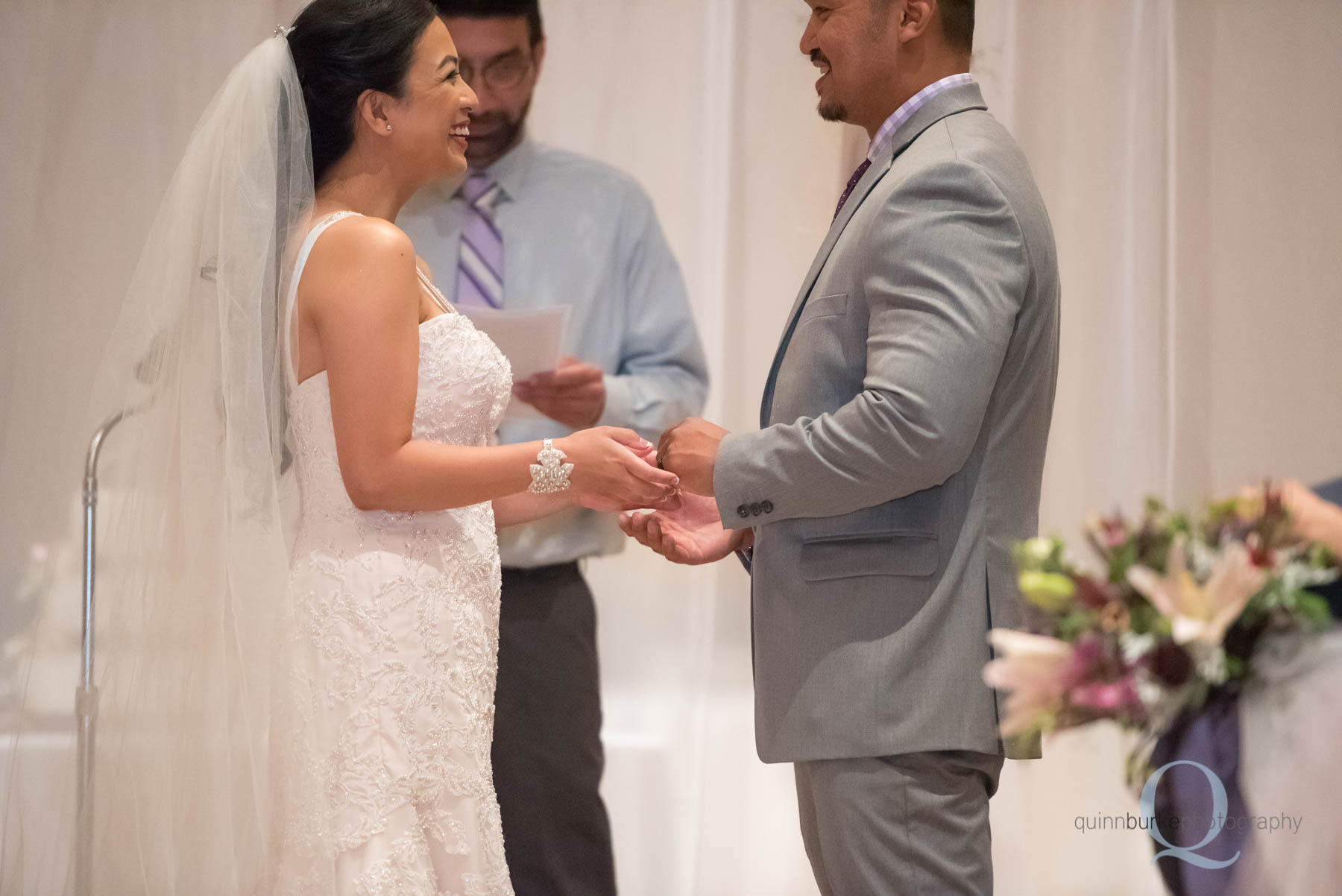 bride placing ring on groom portland wedding