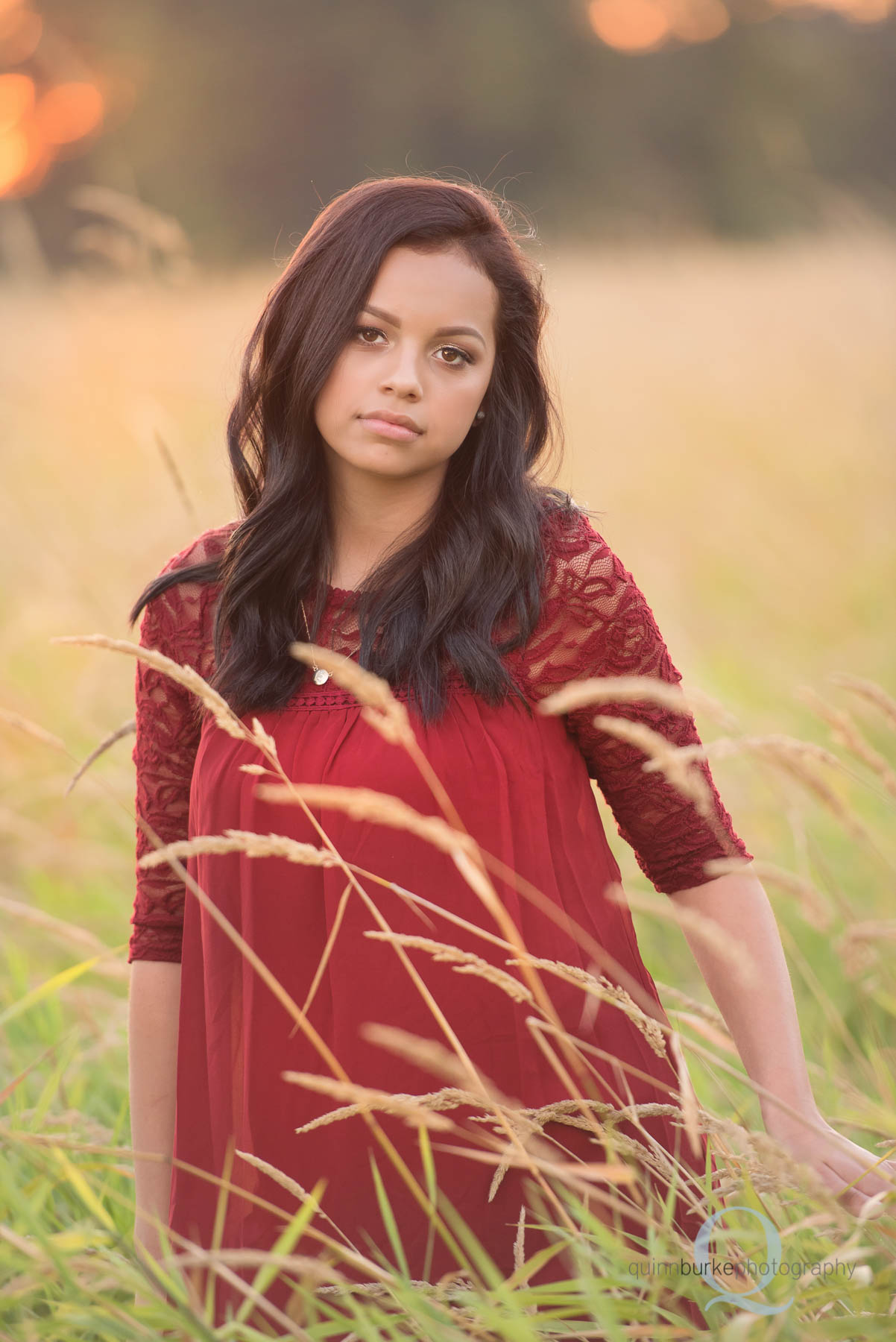 high school senior in red dress in wheat field