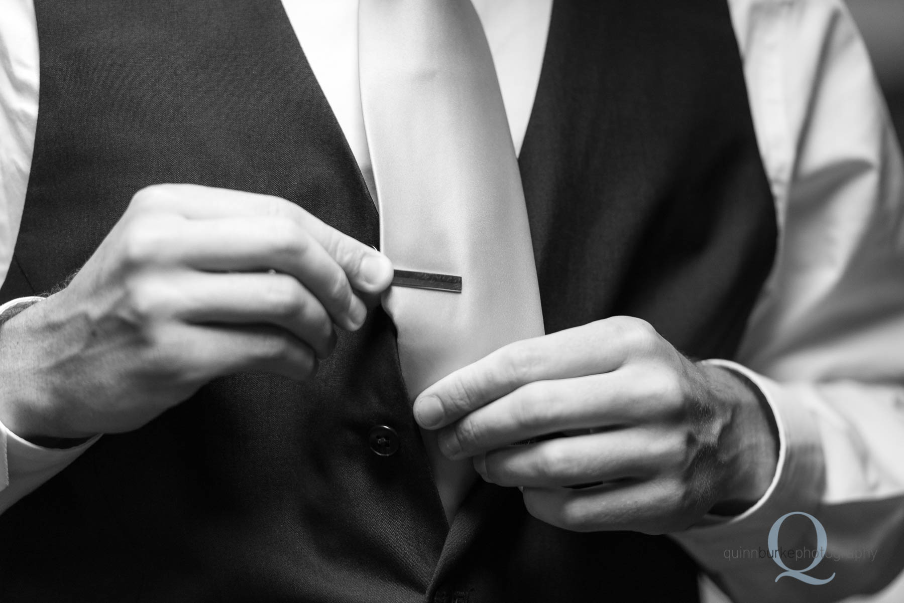 bring putting on tie clip for wedding