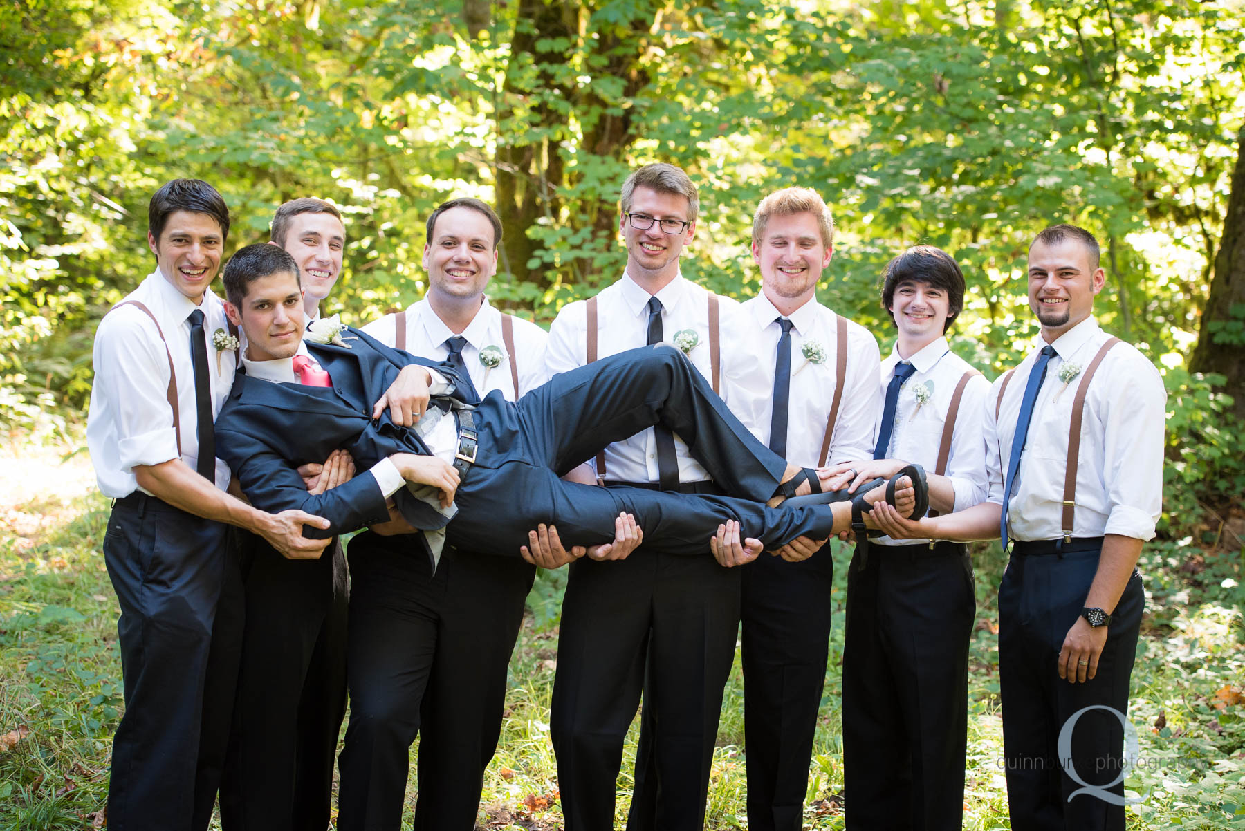 groomsmen picking up groom wedding party