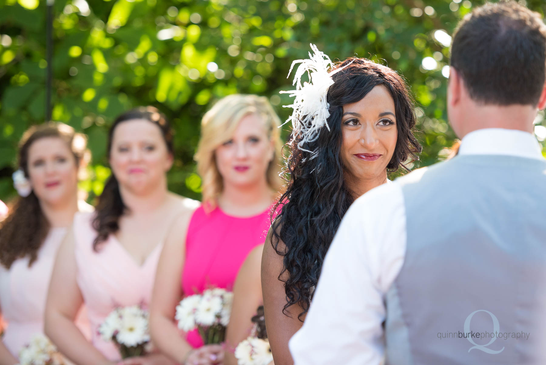 bride smiling at groom during wedding ceremony