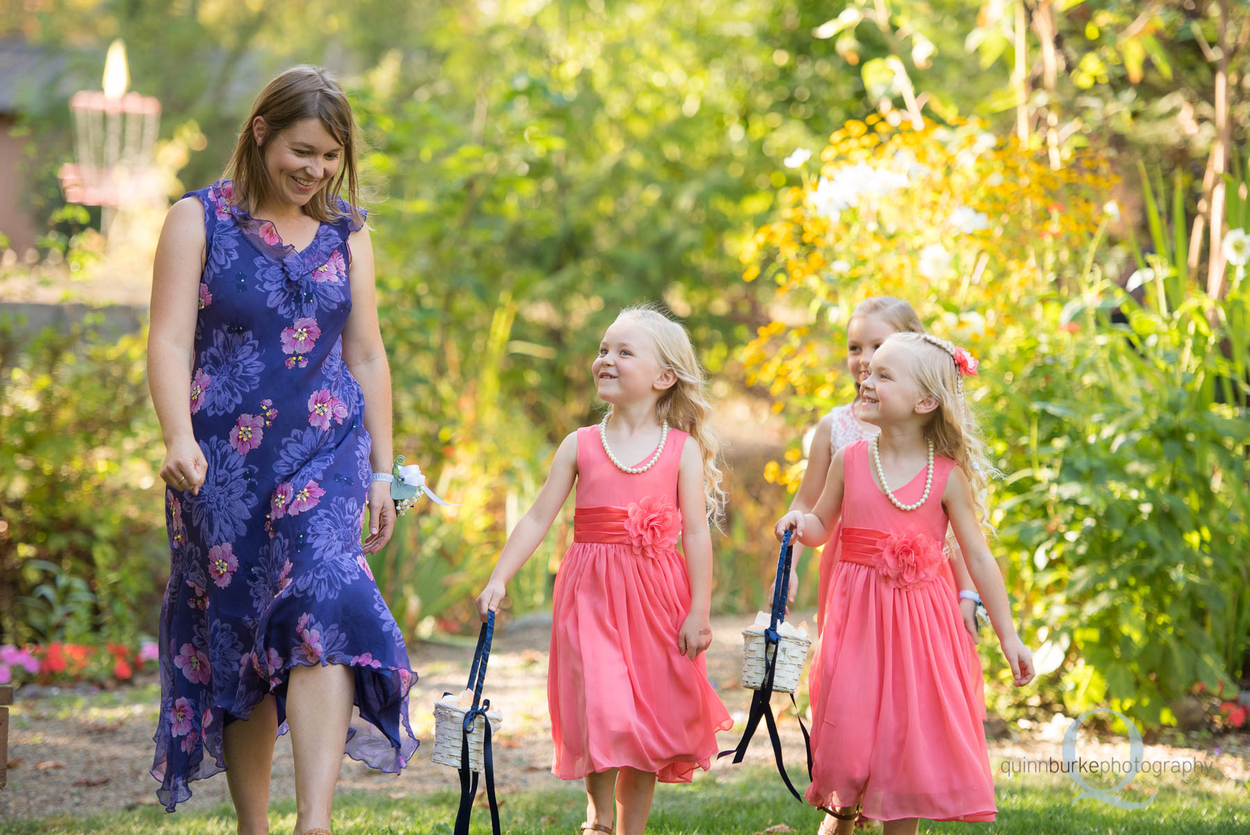 flower girls walking into wedding ceremony