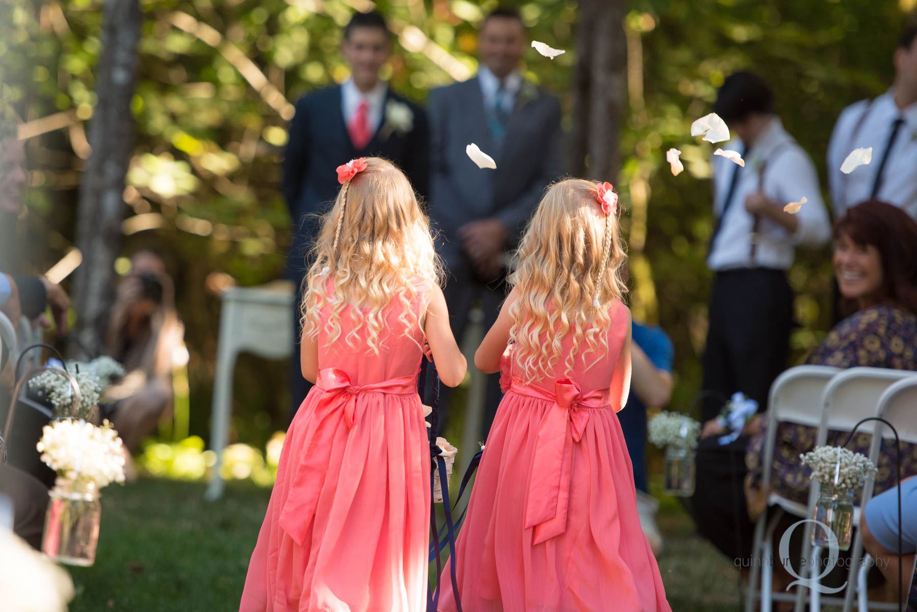 flower girls walking into wedding ceremony