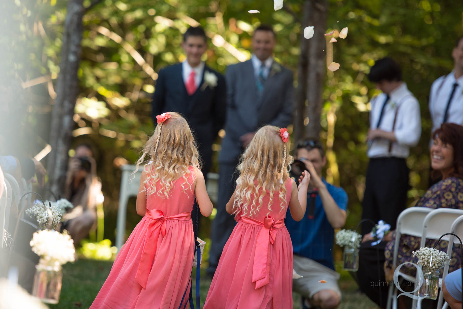 flower girls walking into wedding ceremony