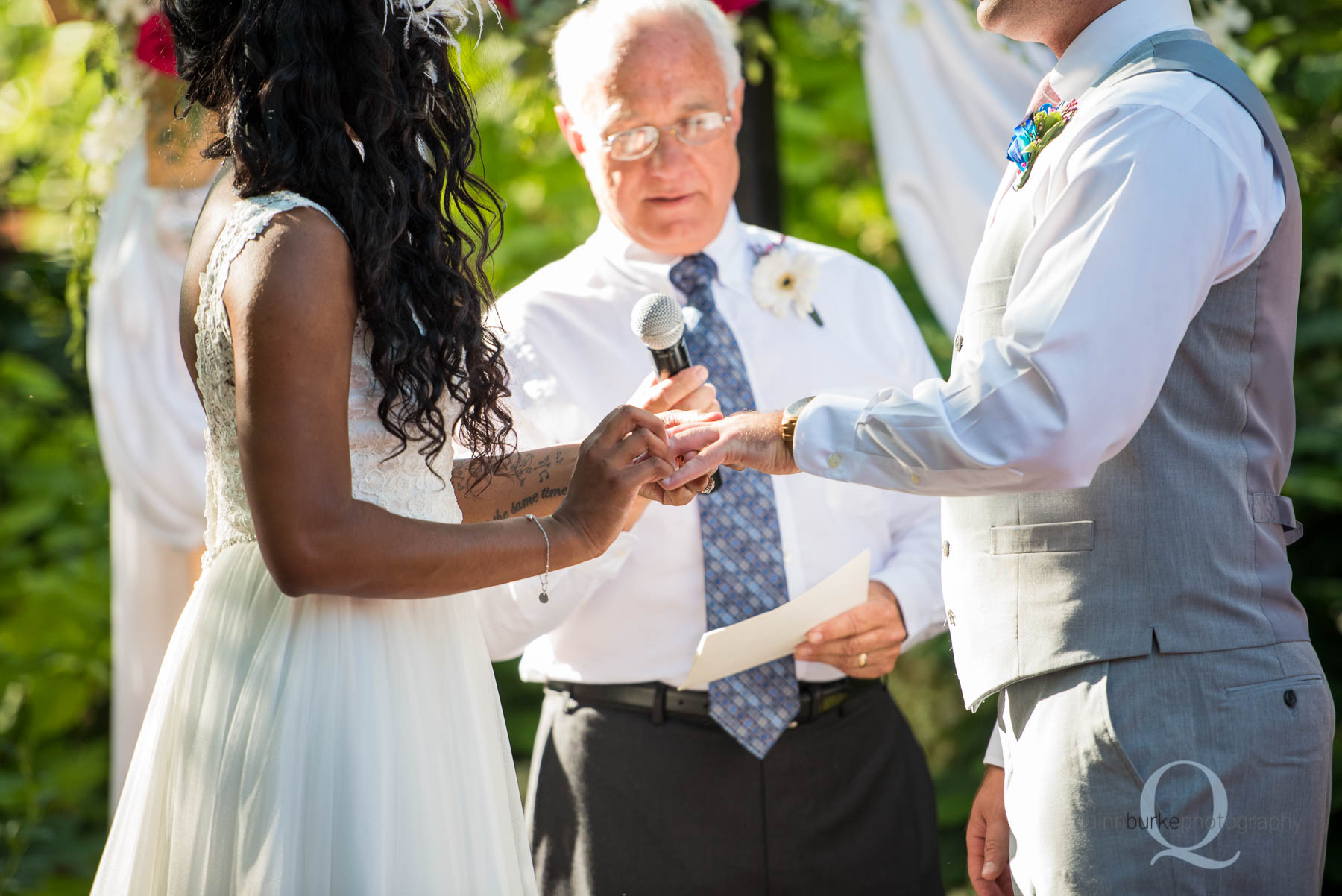bride placing ring on groom's finger