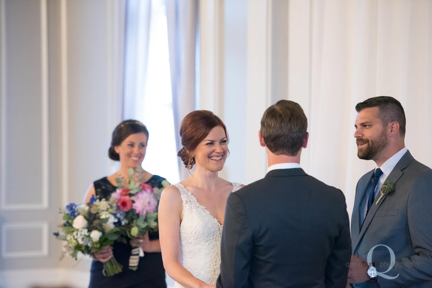 bride smiling at groom during ceremony