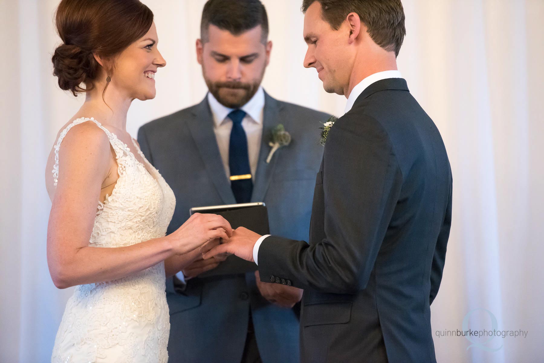 bride placing ring on grooms finger during wedding ceremony Old Schoolhouse Newberg