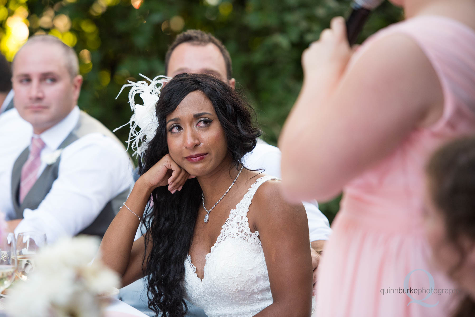 bride crying during toast at wedding reception