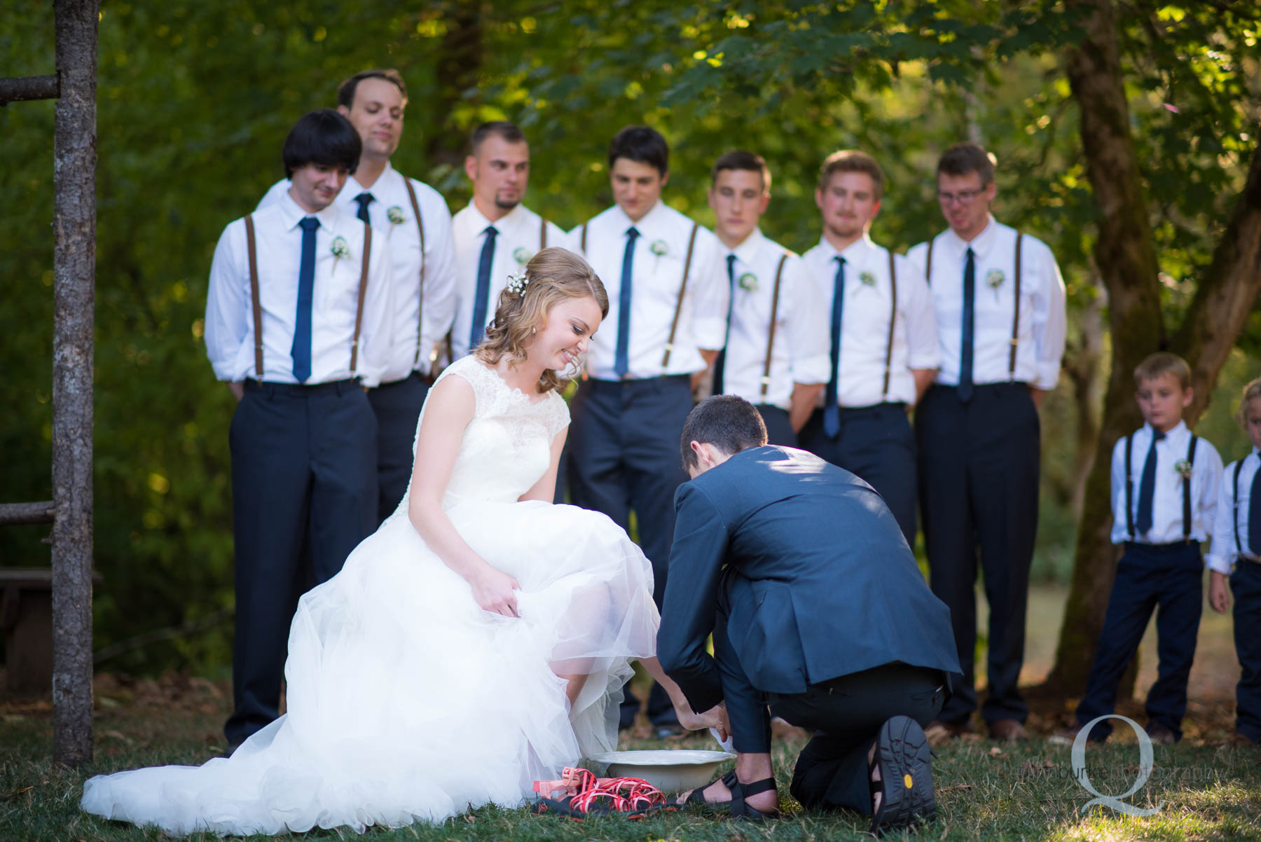 groom washing brides feet during wedding ceremony rons pond