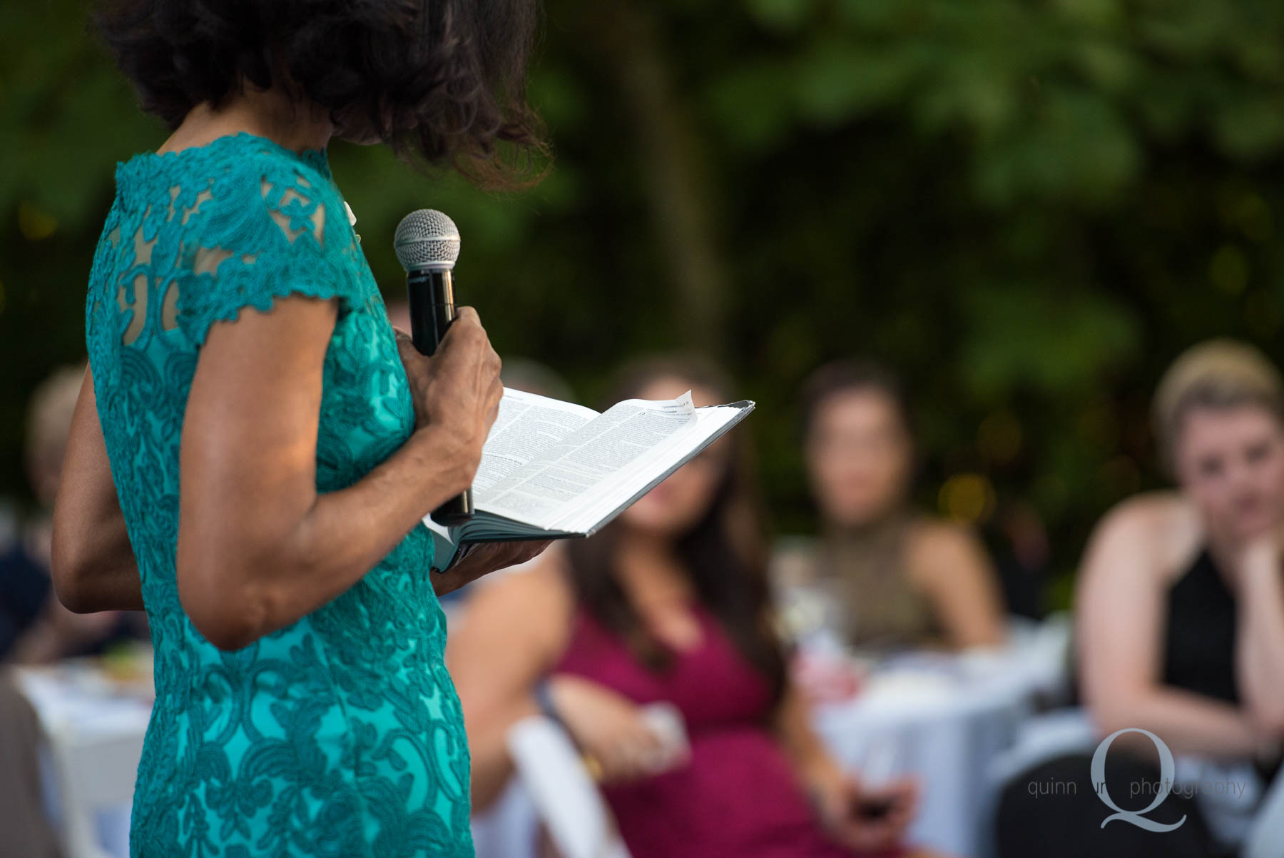 mom reading scripture during wedding reception toast