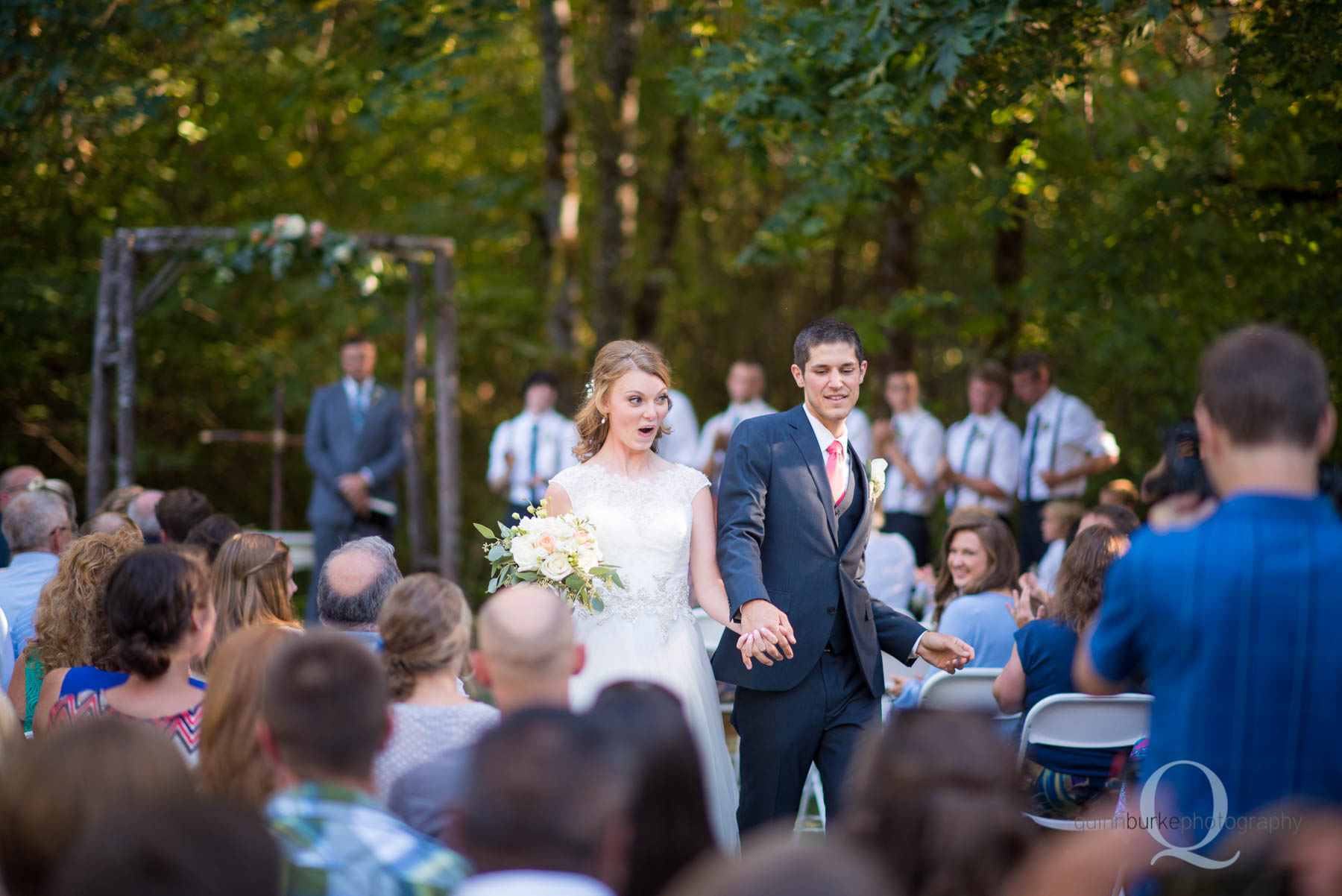 bride and groom walking down aisle after wedding ceremony