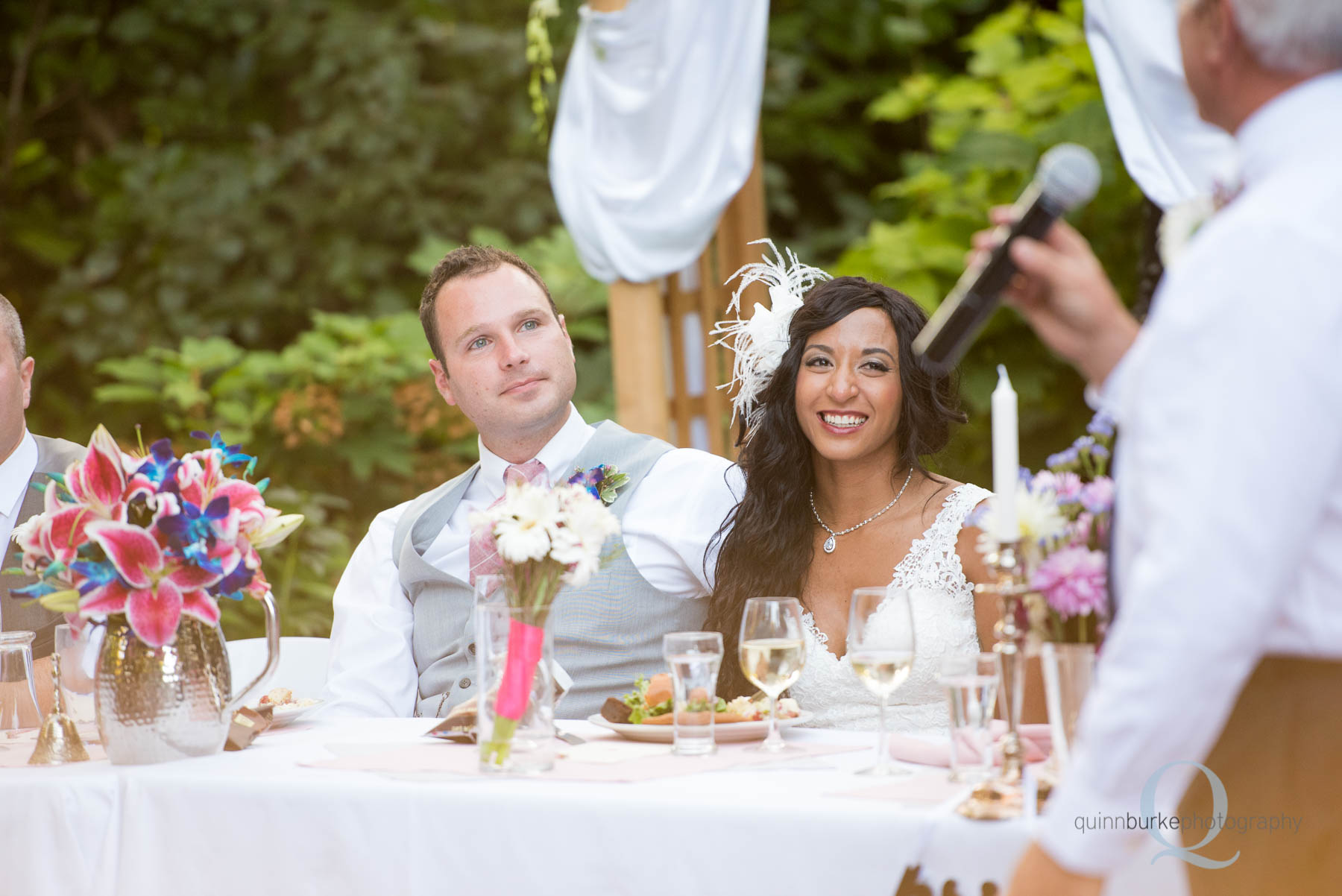 bride and groom listening to toasts at wedding