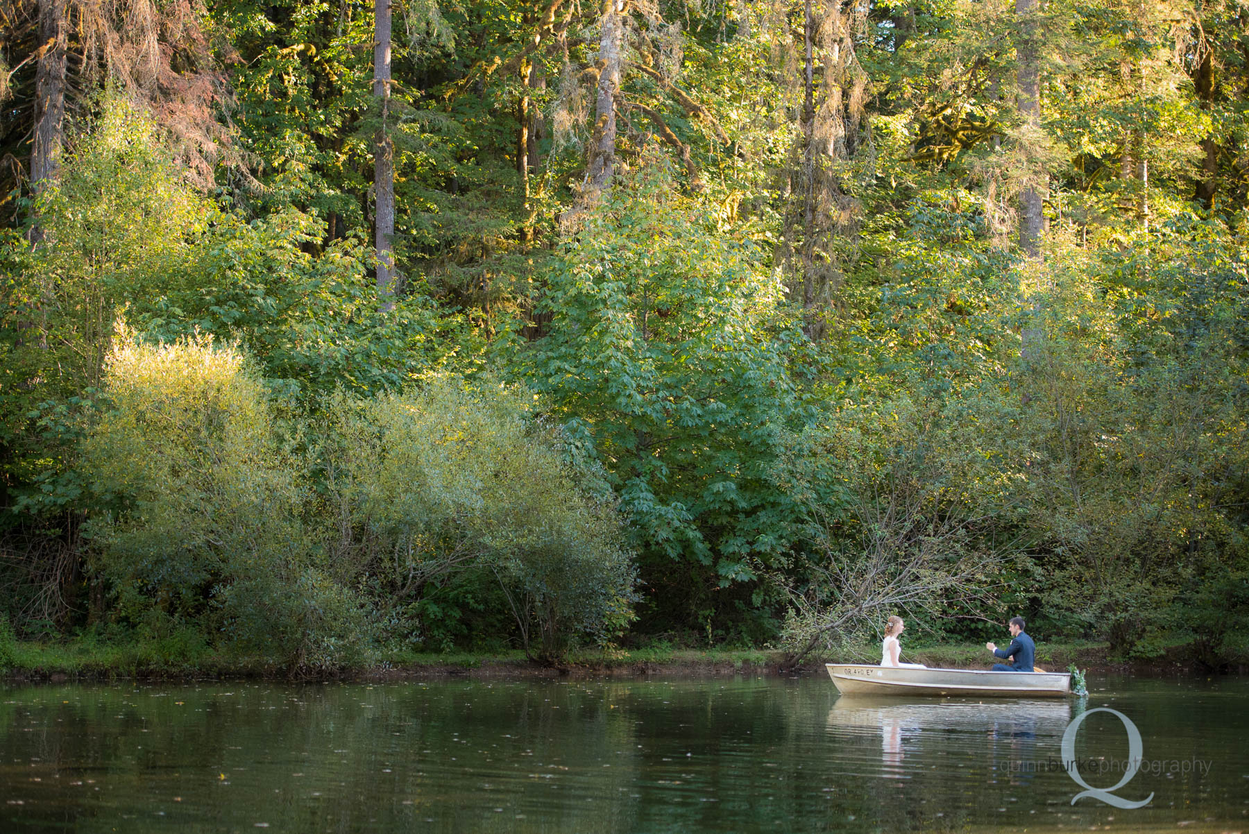 bride and groom in boat at rons pond wedding