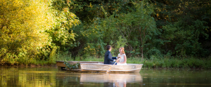 bride and groom boat on pond rons pond wedding