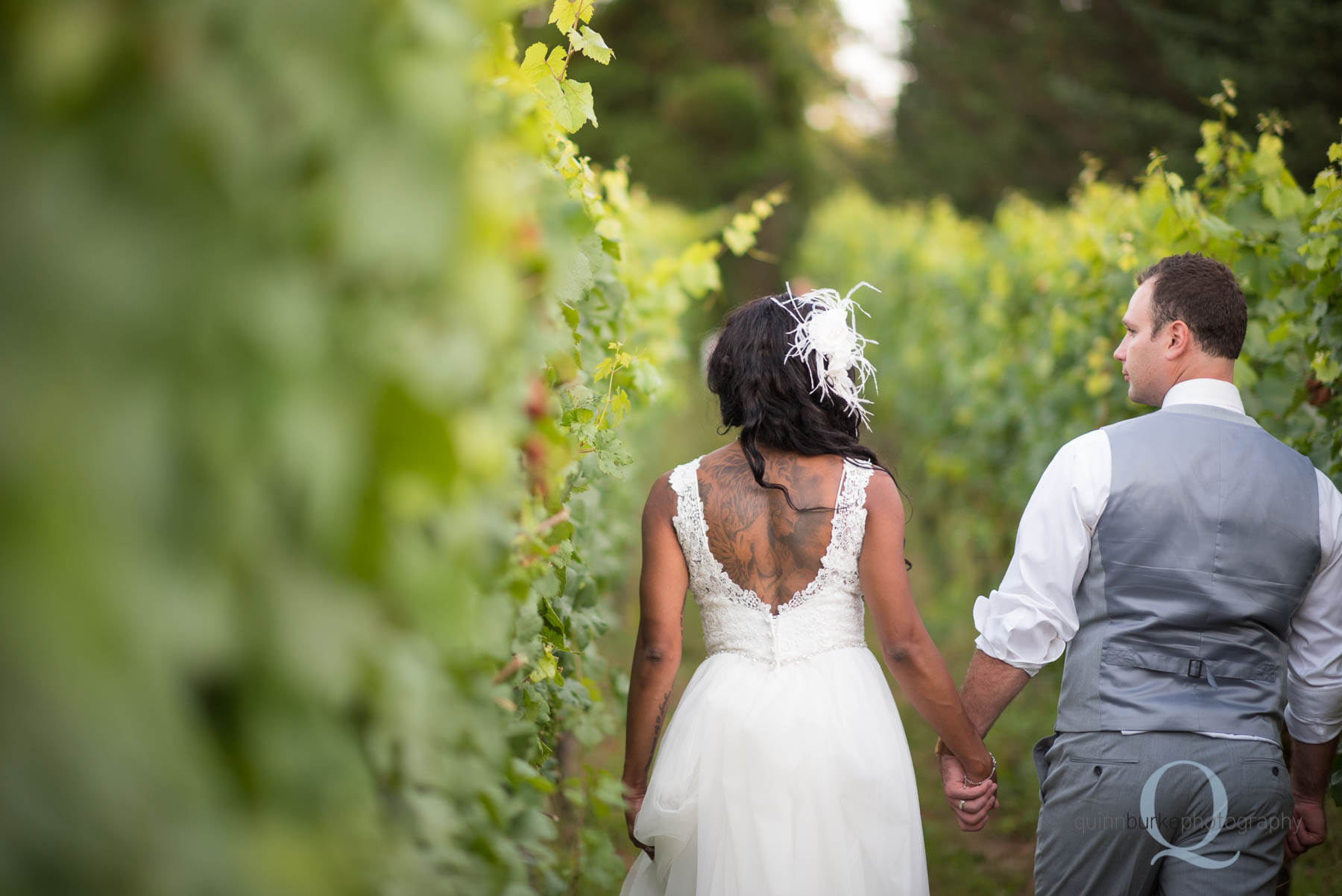 bride and groom walking in vineyard at Mcmenamins edgefield