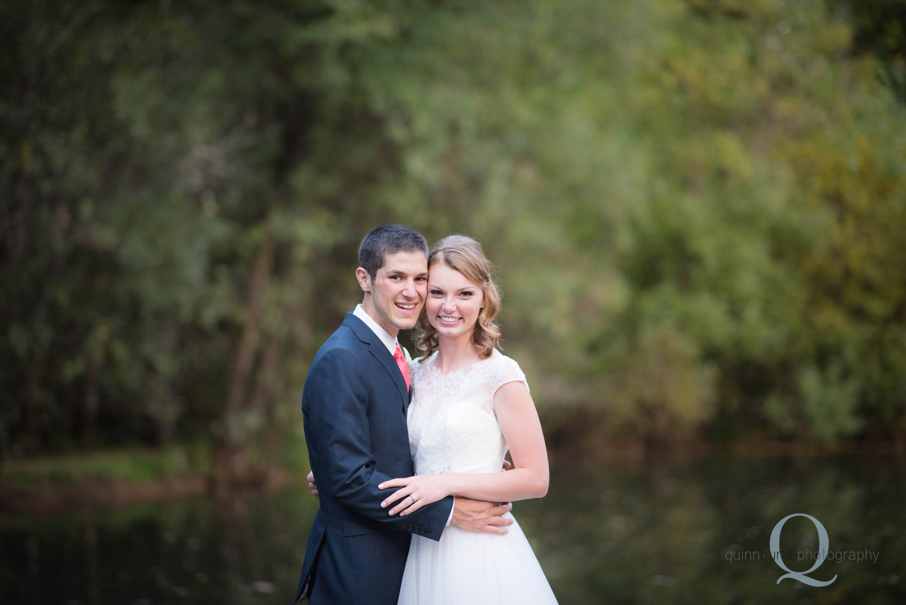 bride and groom in front of pond at rons pond wedding