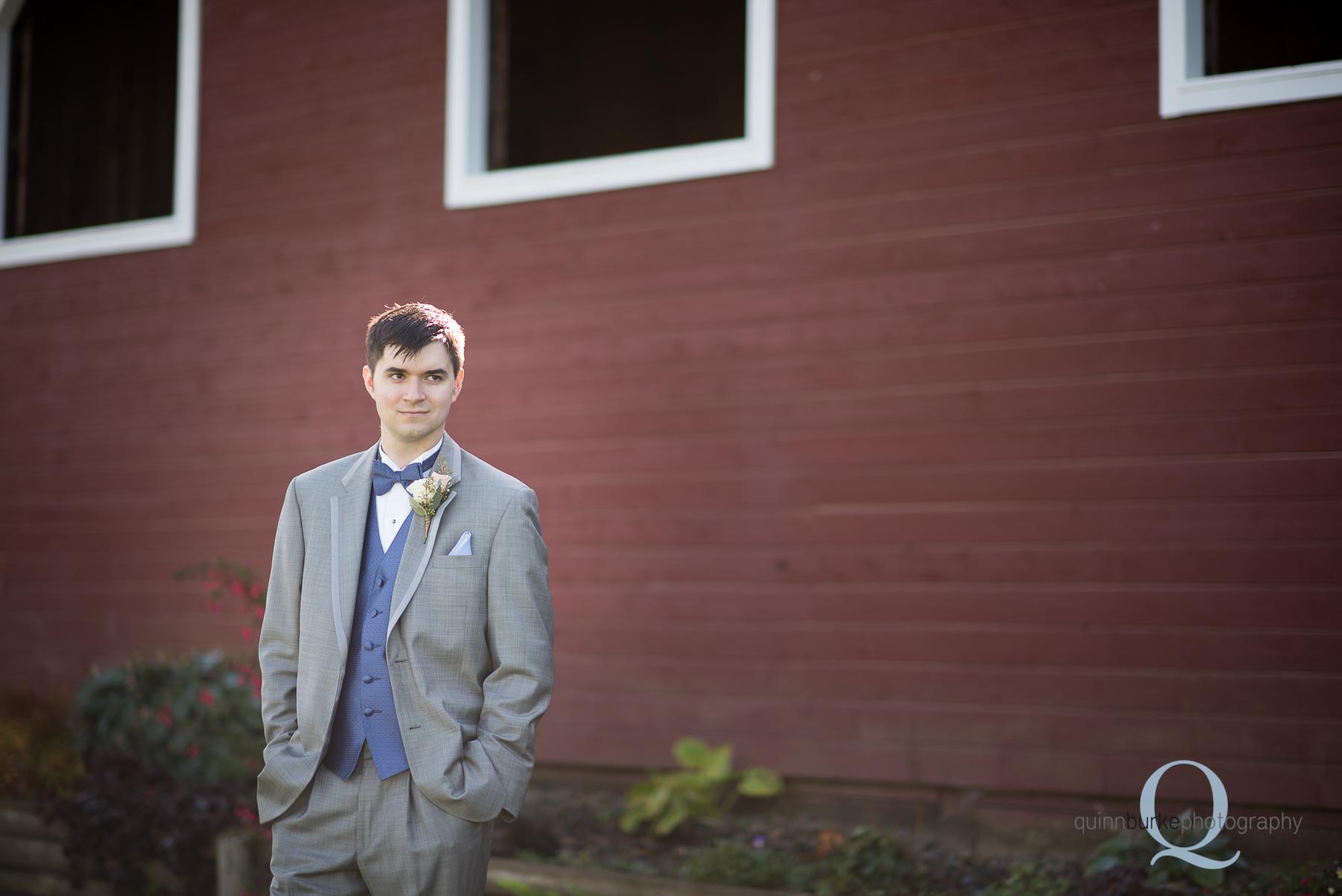 groom outside of barn at Perryhill Farm wedding