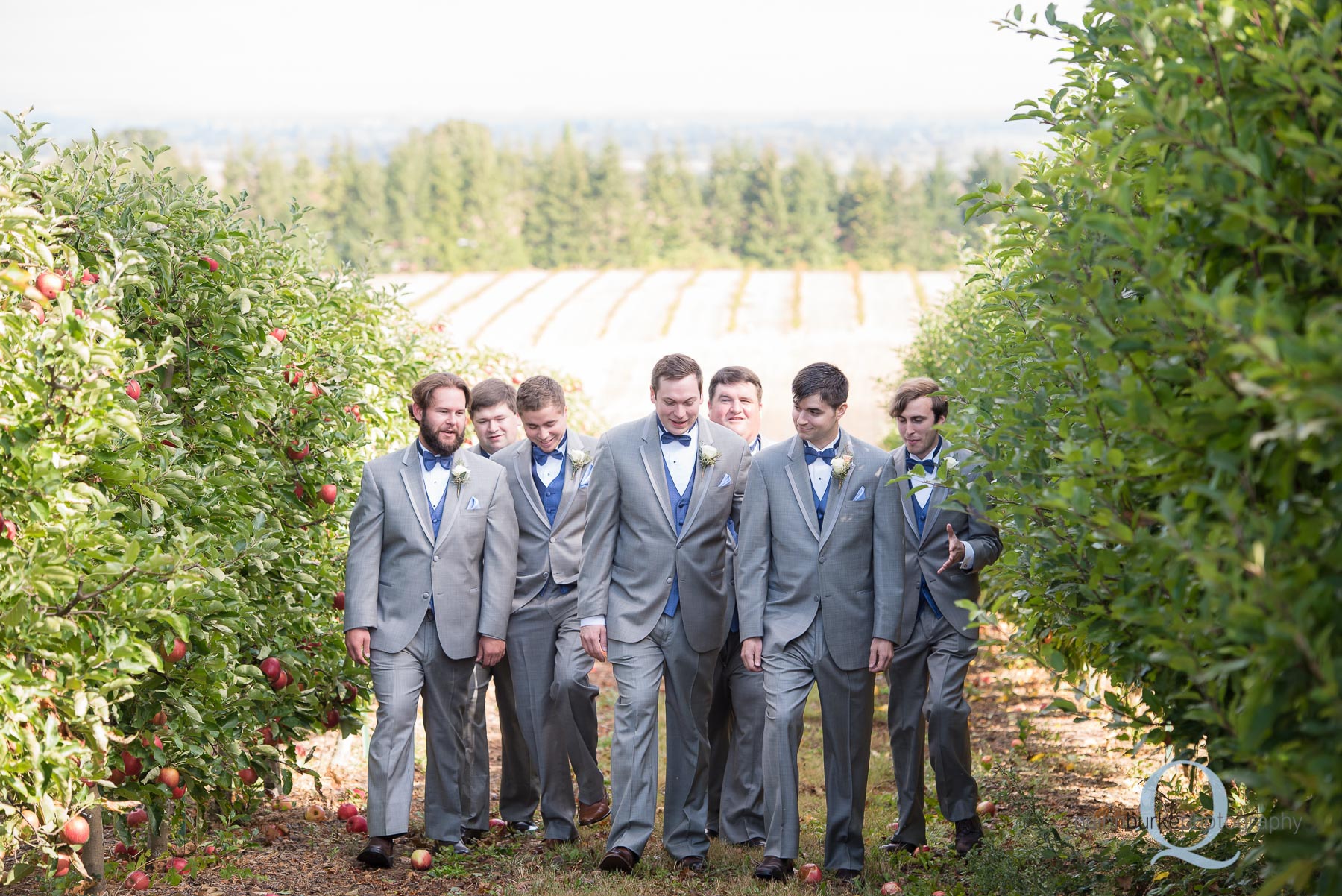 groomsmen walking in orchard at Perryhill Farm