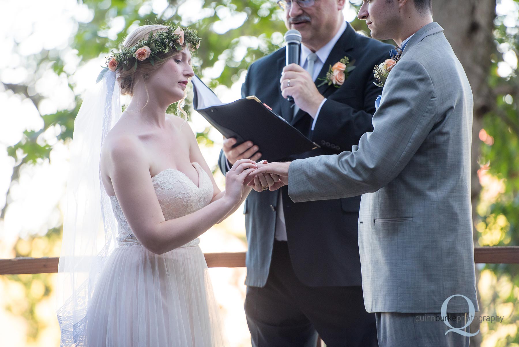 bride placing ring on grooms finger at Perryhill Farm oregon