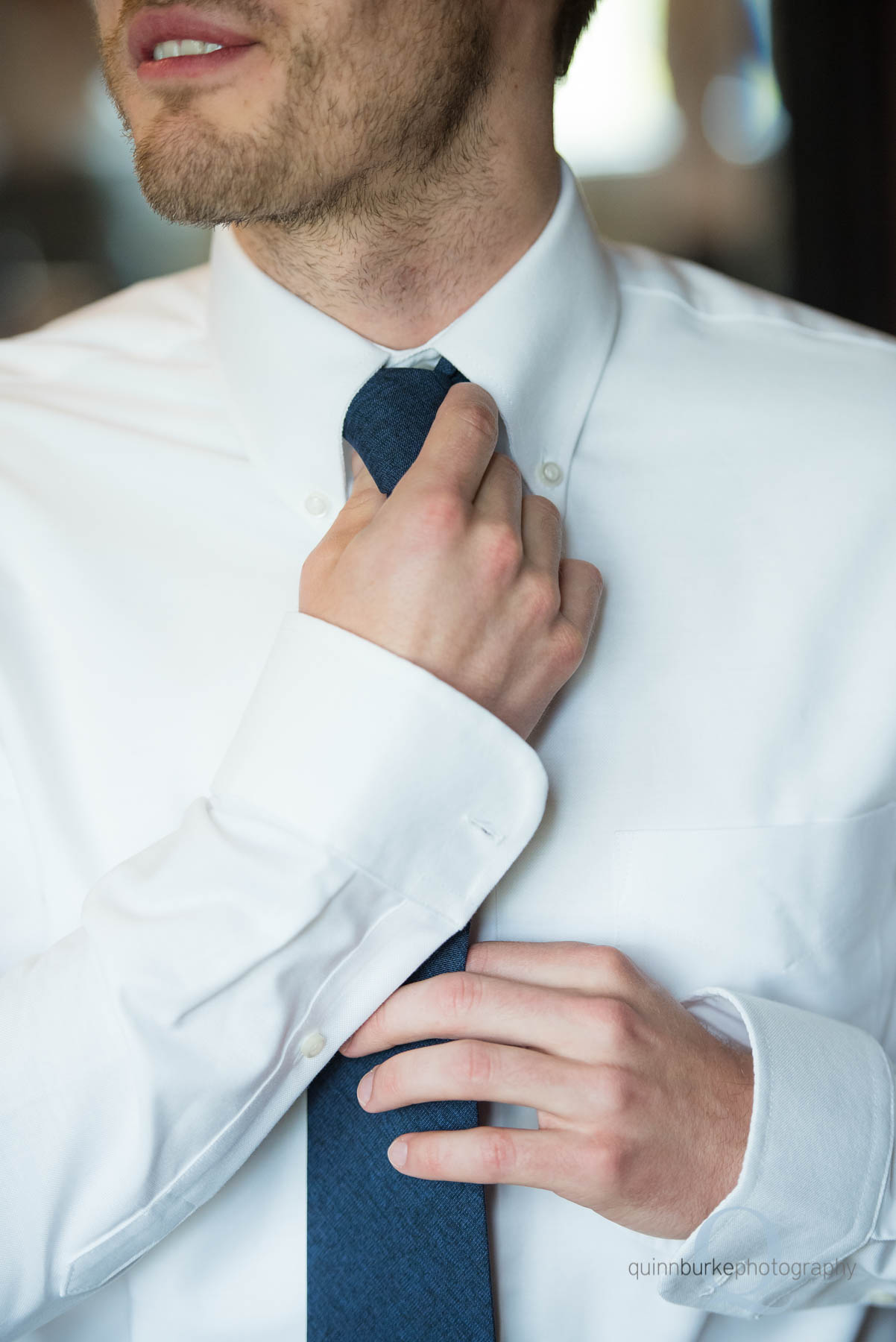 groom straightening tie know at Green Villa Barn