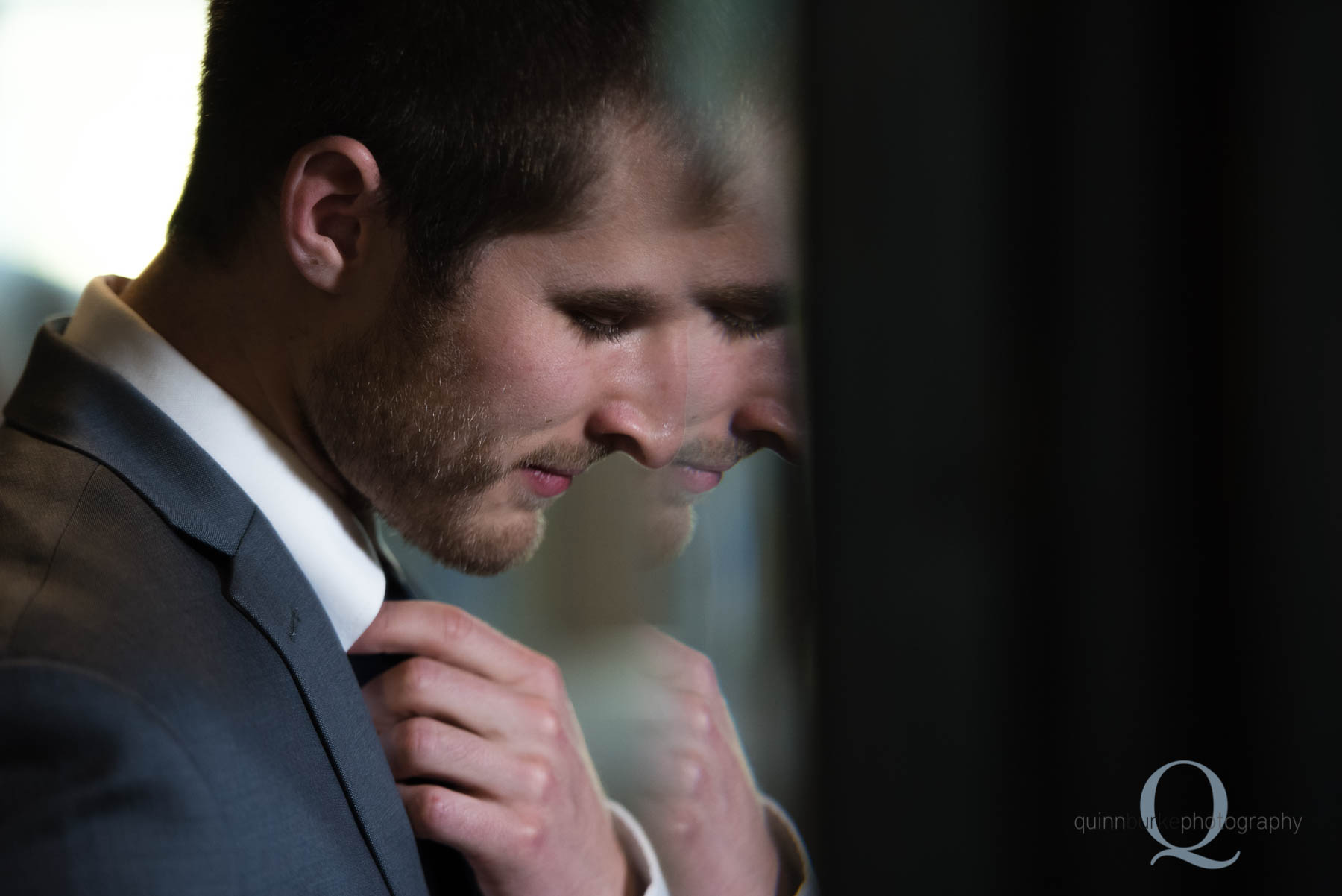 groom in beveled mirror reflection Green Villa Barn