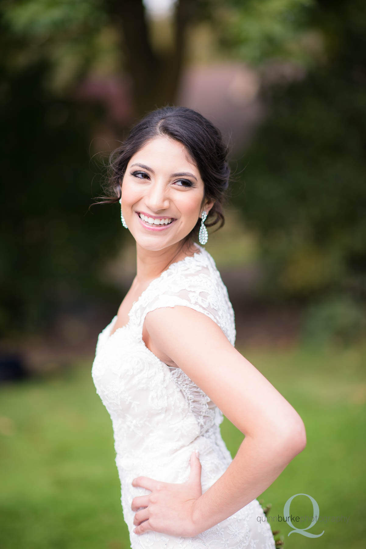 bride turning over shoulder at Green Villa Barn