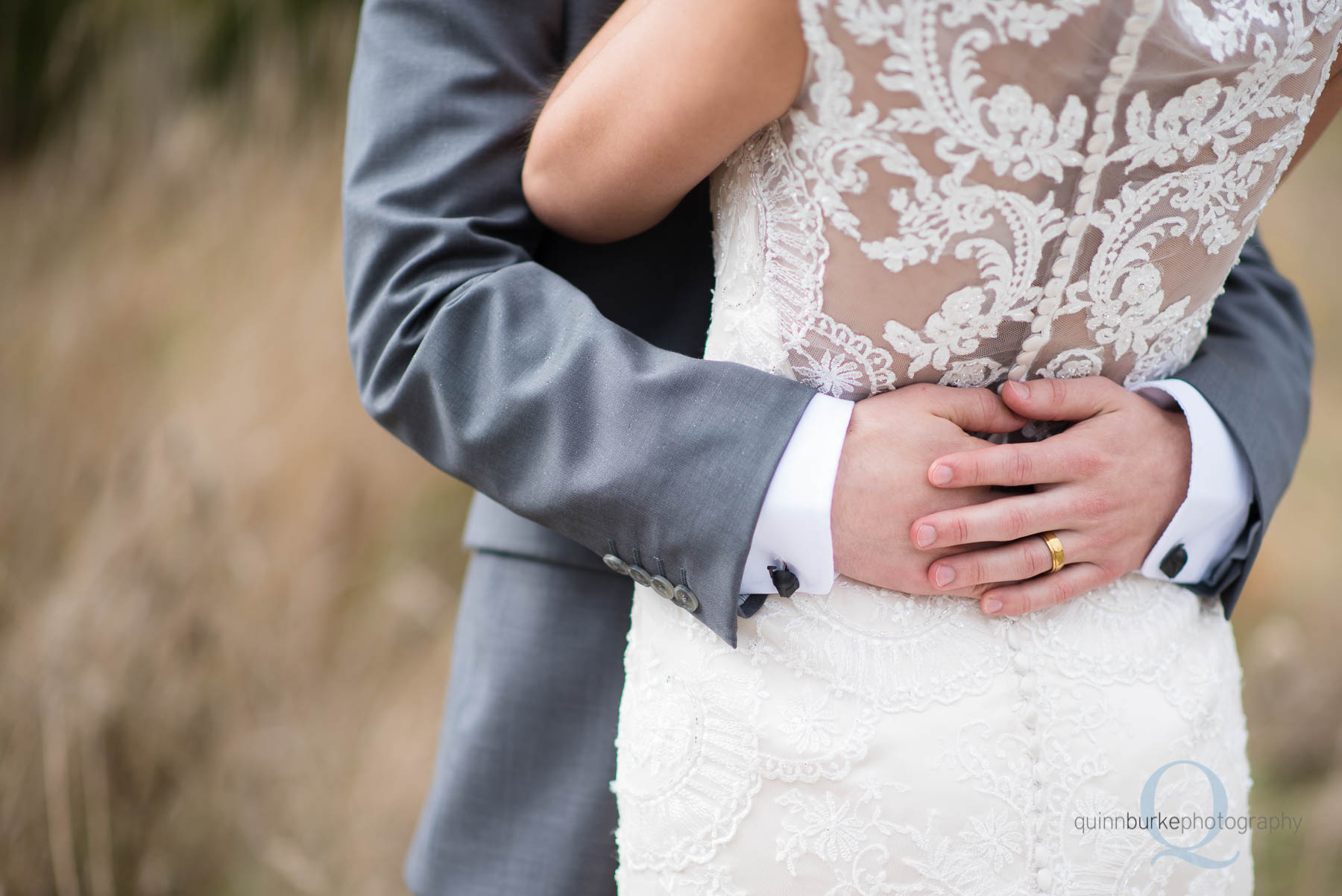 groom holding bride hands closeup