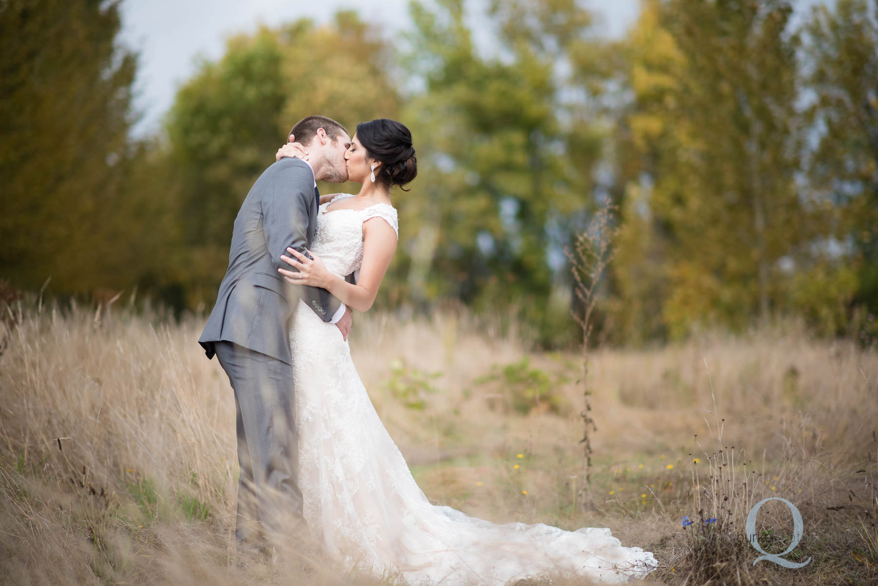 groom kissing bride at Green Villa Barn wedding