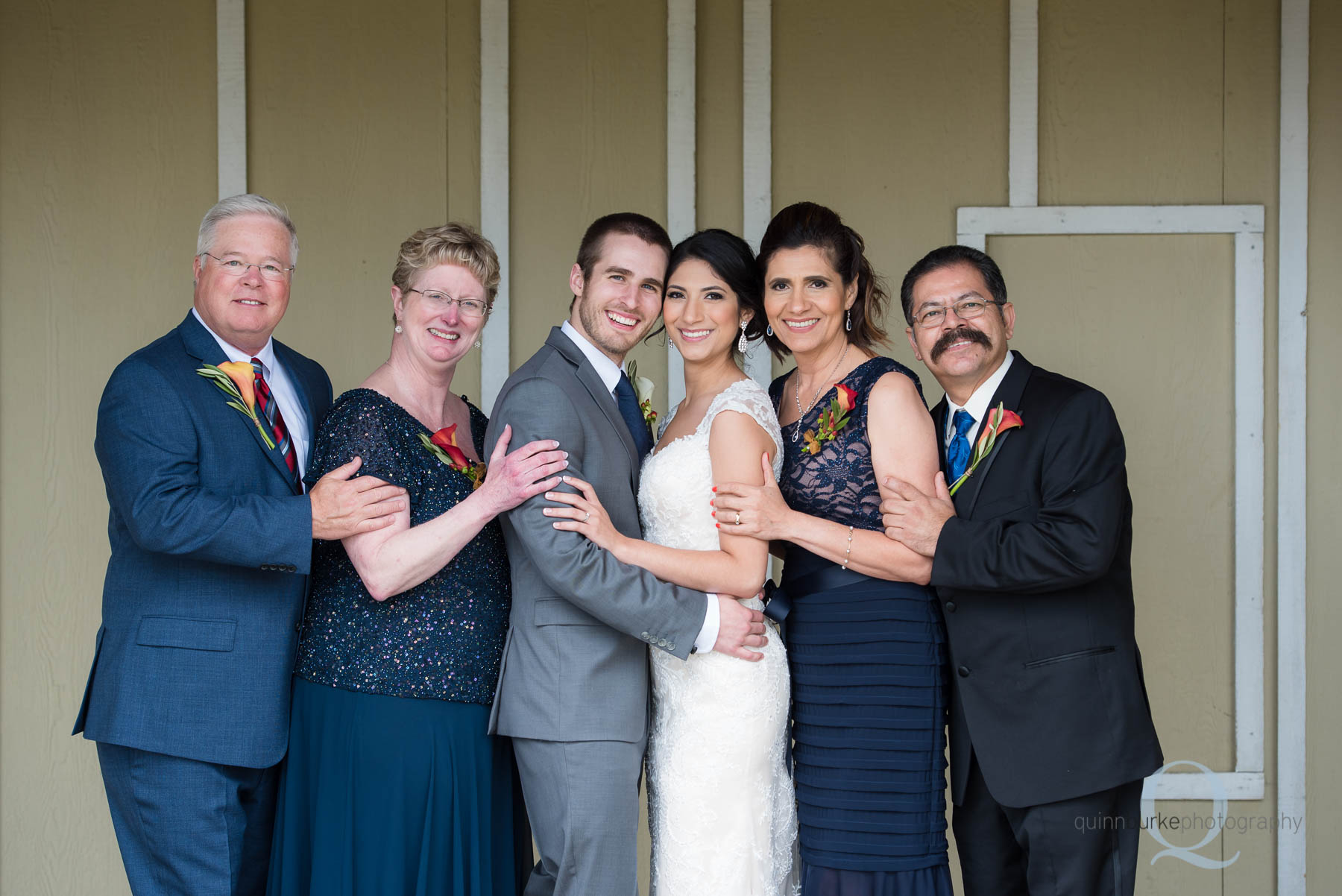 bride and groom with parents at Green Villa Barn wedding