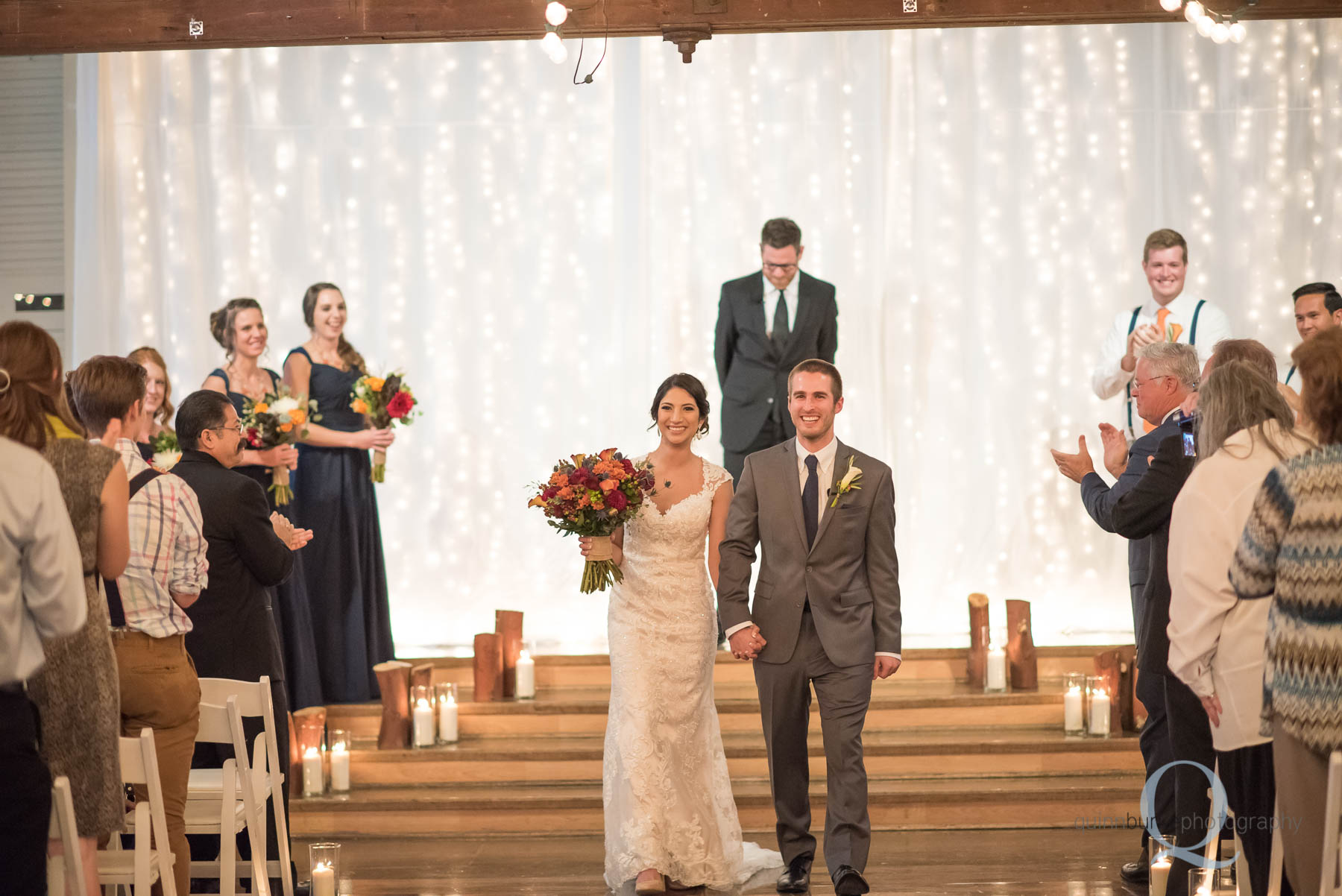 bride and groom walk down aisle Green Villa Barn