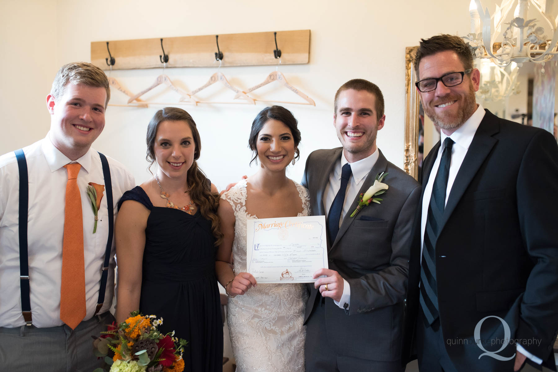 bride and groom hold wedding certificate Green Villa Barn