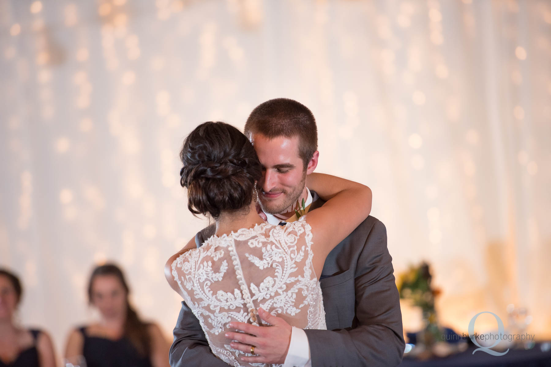 groom hugs bride during first dance at Green Villa Barn