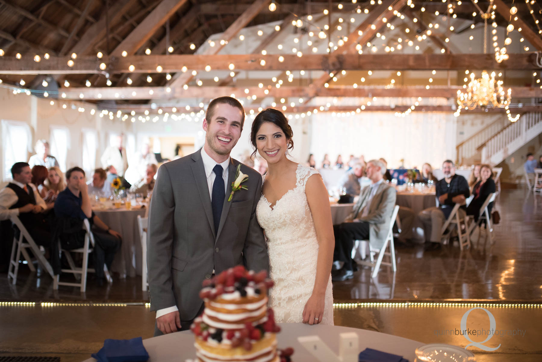 bride and groom with wedding cake at Green Villa Barn